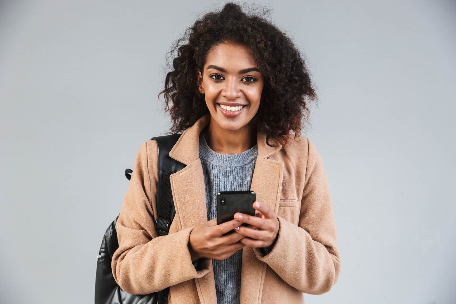 Smiling Woman Holding a Smartphone